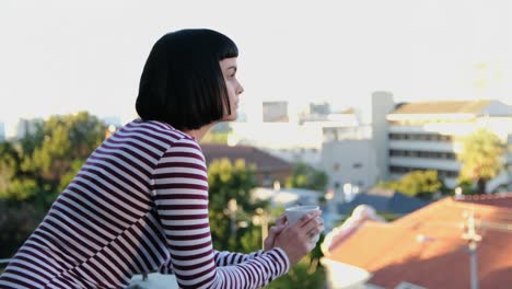 Woman-having-coffee-in-the-balcony-4k