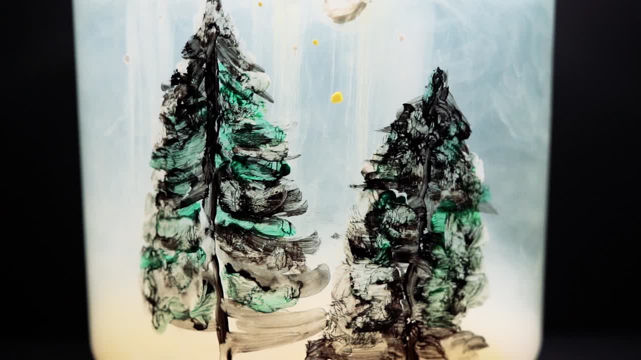 White paint floating in water tank with pine tree drawing inside. Stable shot with the Sony a7iii.