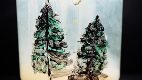 white paint floating in water tank with pine tree drawing inside. stable shot with the sony a7iii.