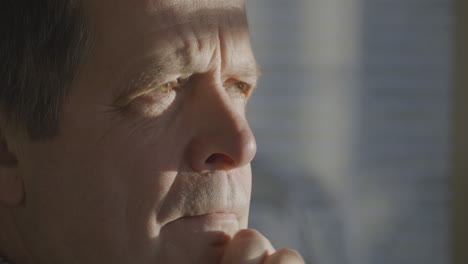 elder man shows disbelief while looking at distance, close up view