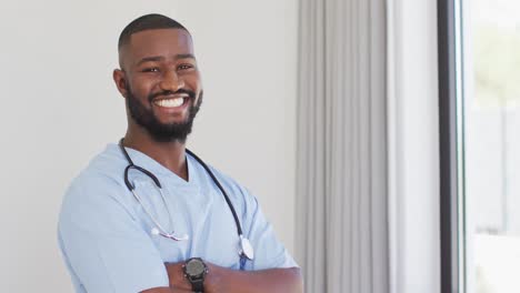 video of happy african american male doctor looking at camera