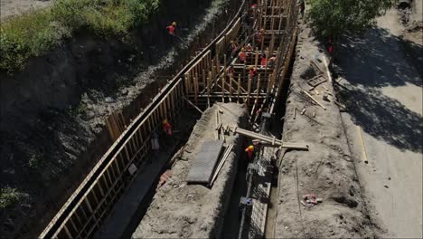 Aerial-drone-view-of-sewer-channel-in-unfinished-city-park-construction-4K-video