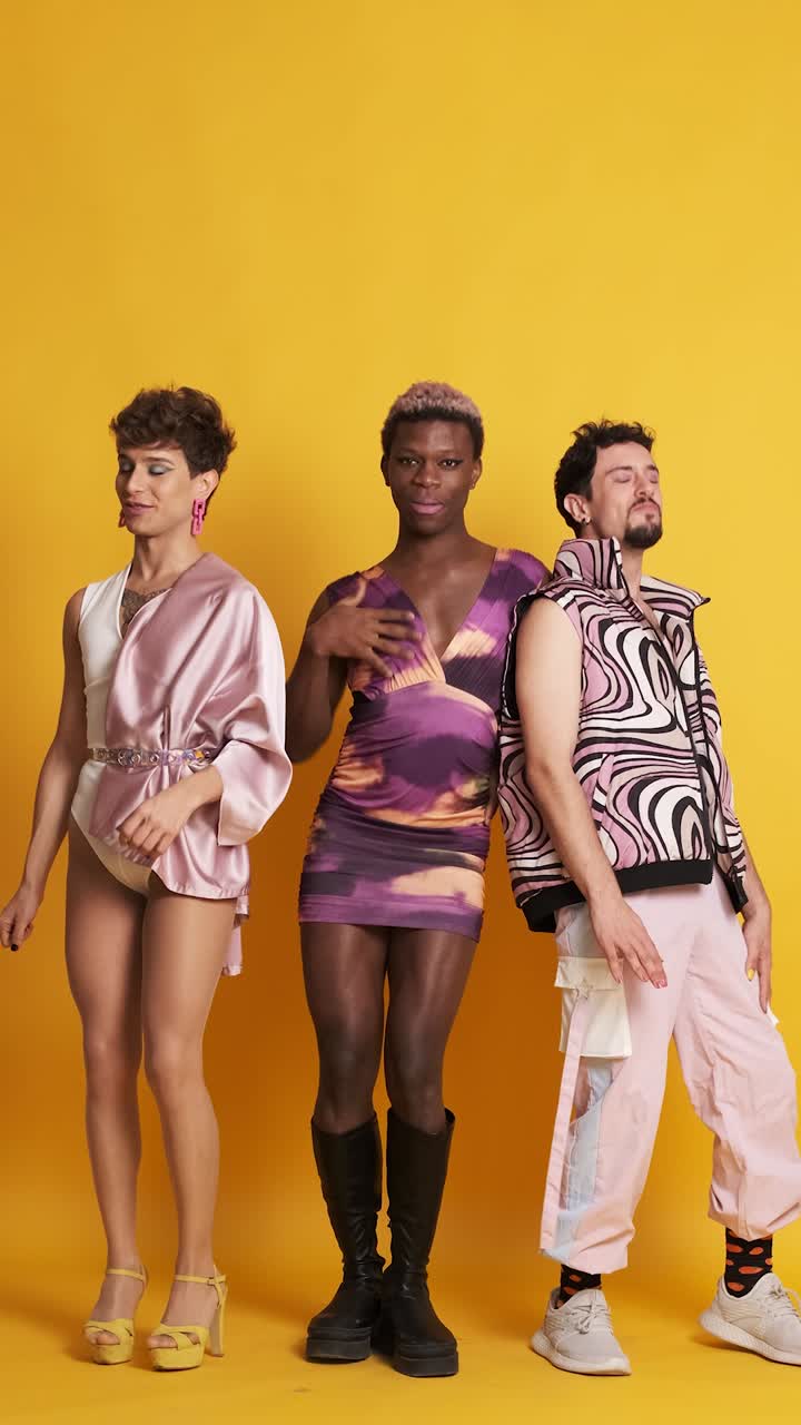 Happy multiethnic transgender men dancing and having fun