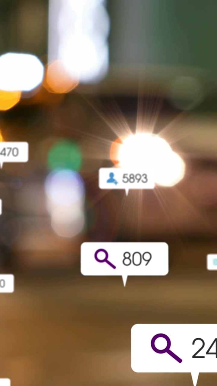 Animation of social media icons and numbers on banners over out of focus traffic in city