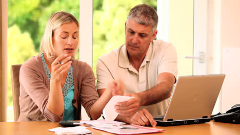 troubled couple doing their accounts