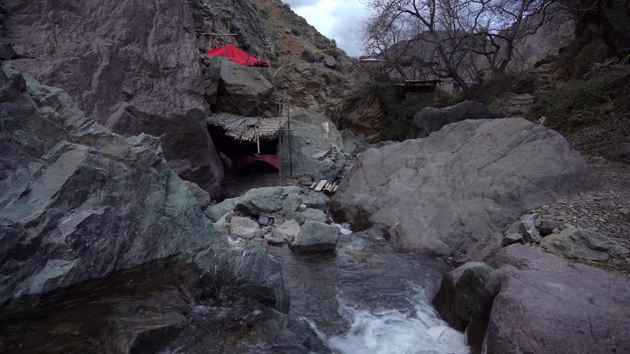 The Cascade Imlil flows silently, surrounded by thick clouds that add to the moody atmosphere, offering a peaceful retreat in Morocco at dusk