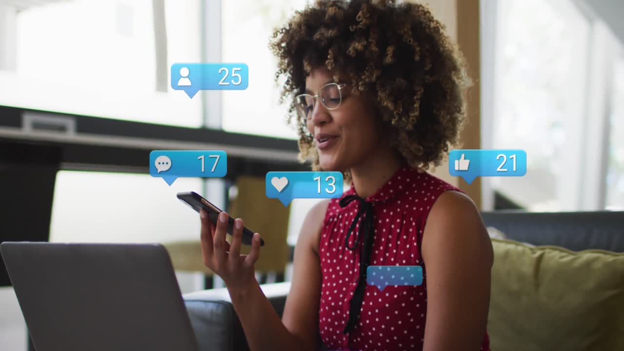 Animation of media icons over african american woman using smartphone