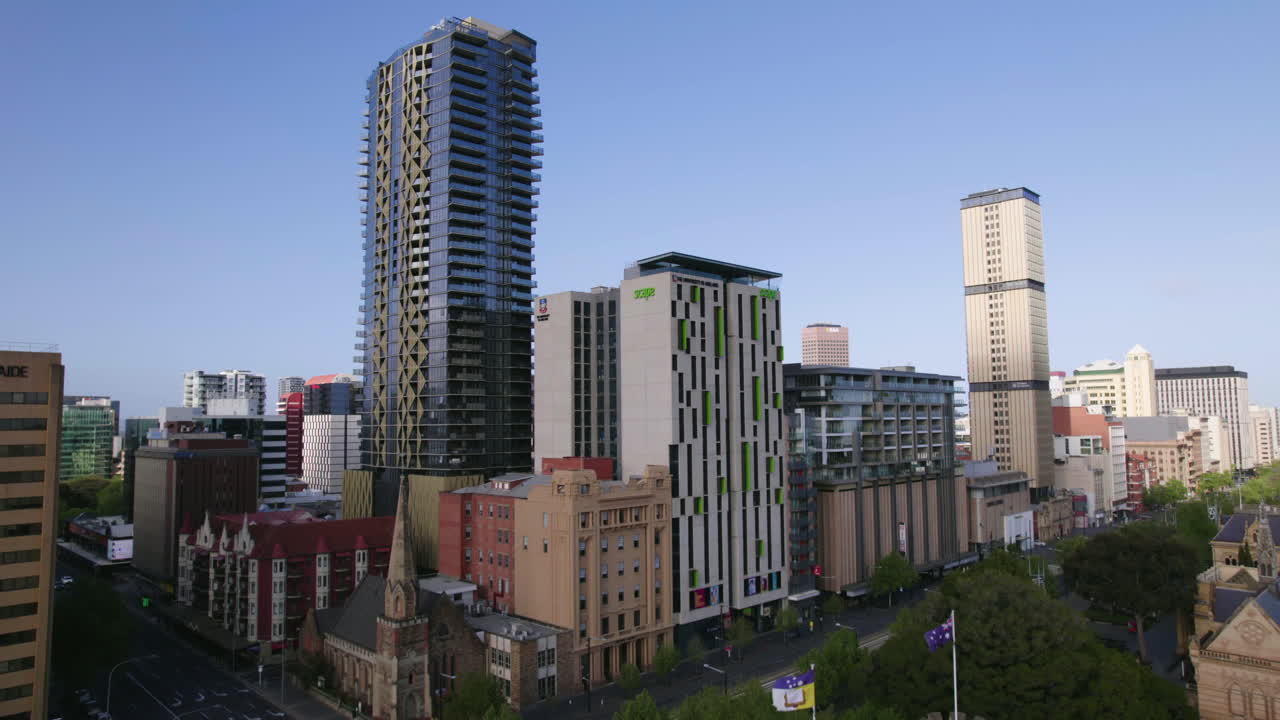 Aerial view ascending in front of the Bonython Hall and sunny Adelaide skyline