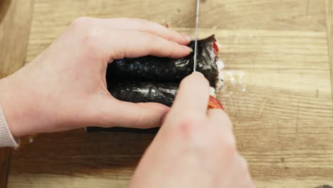 cutting homemade sushi rolls, top down view