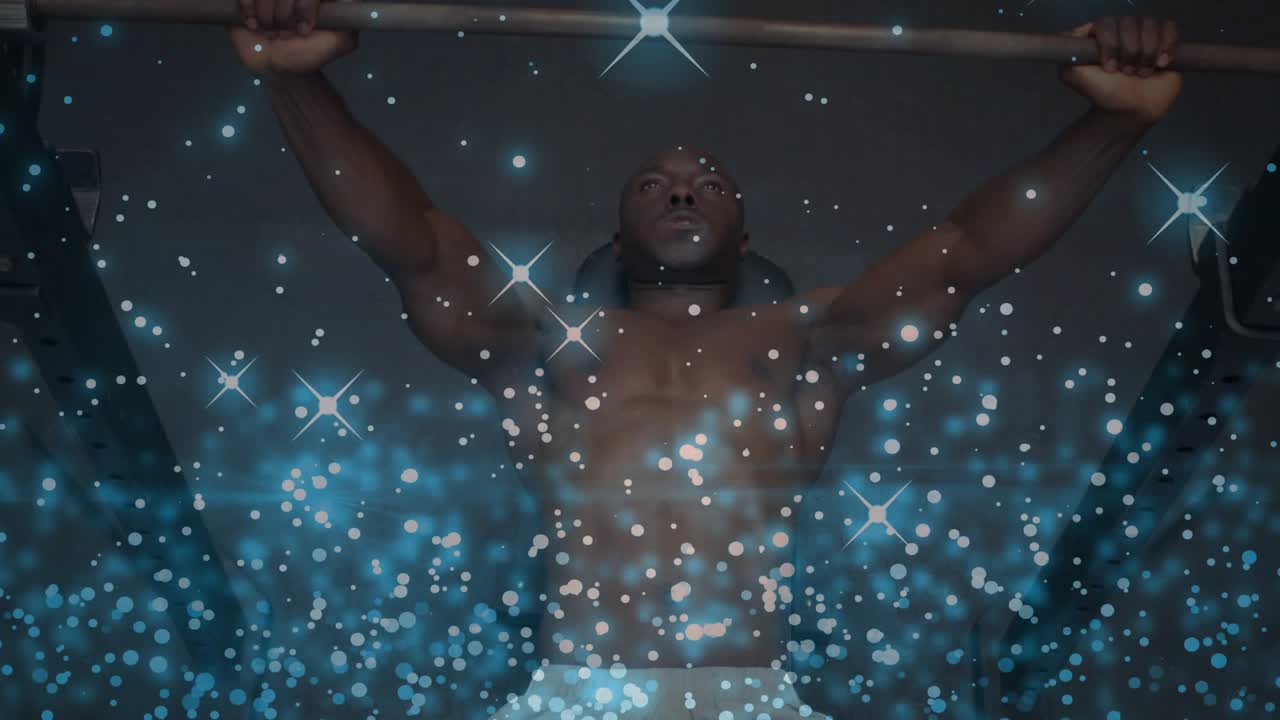 Man gripping bar starting bench pressing for fitness, raising bar while blue stars overlaying torso