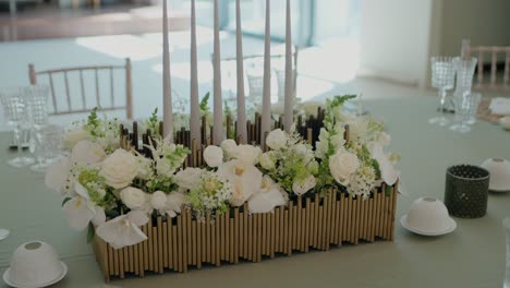 beautiful table centerpiece featuring white flowers and tall candles