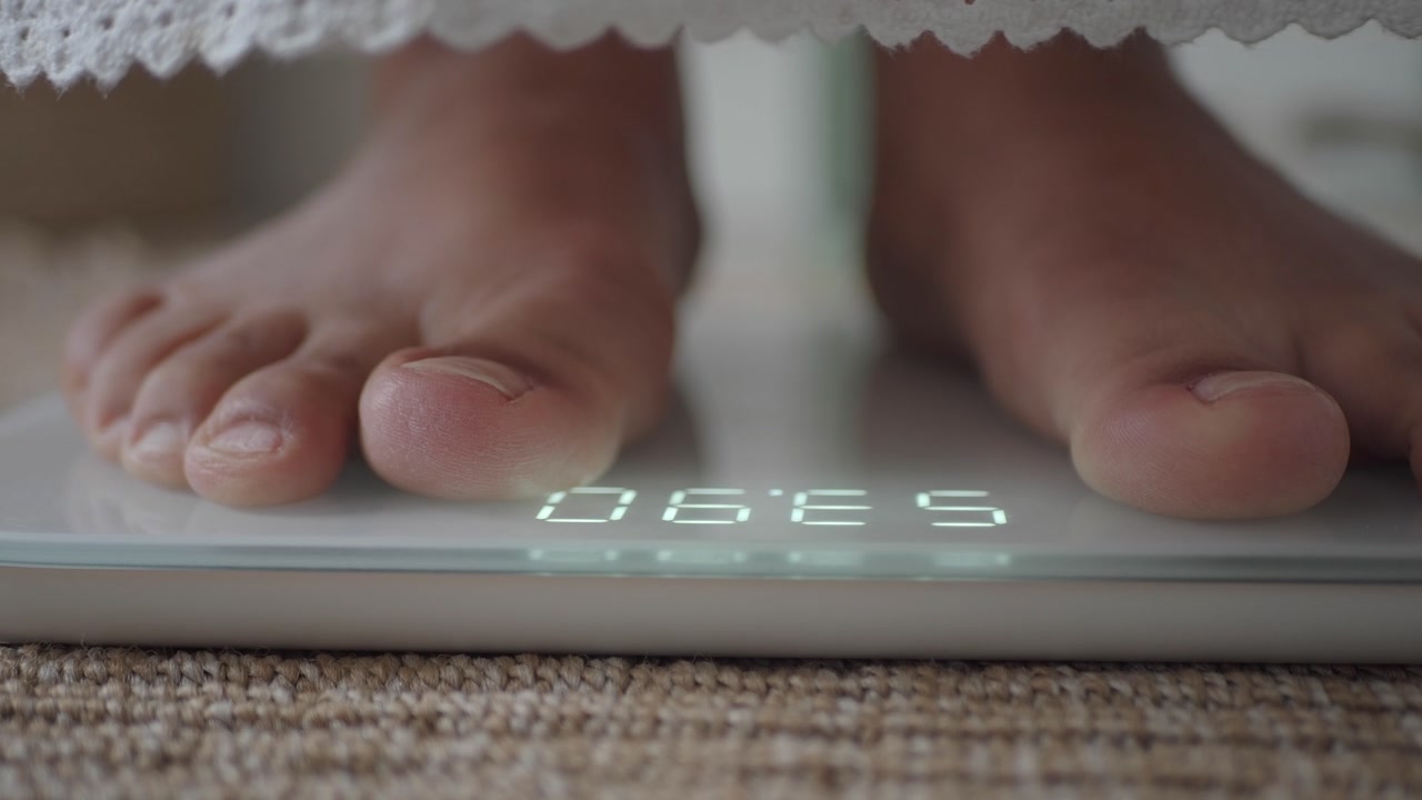 Bare Feet Stepping on Digital Scale to Measure Weight