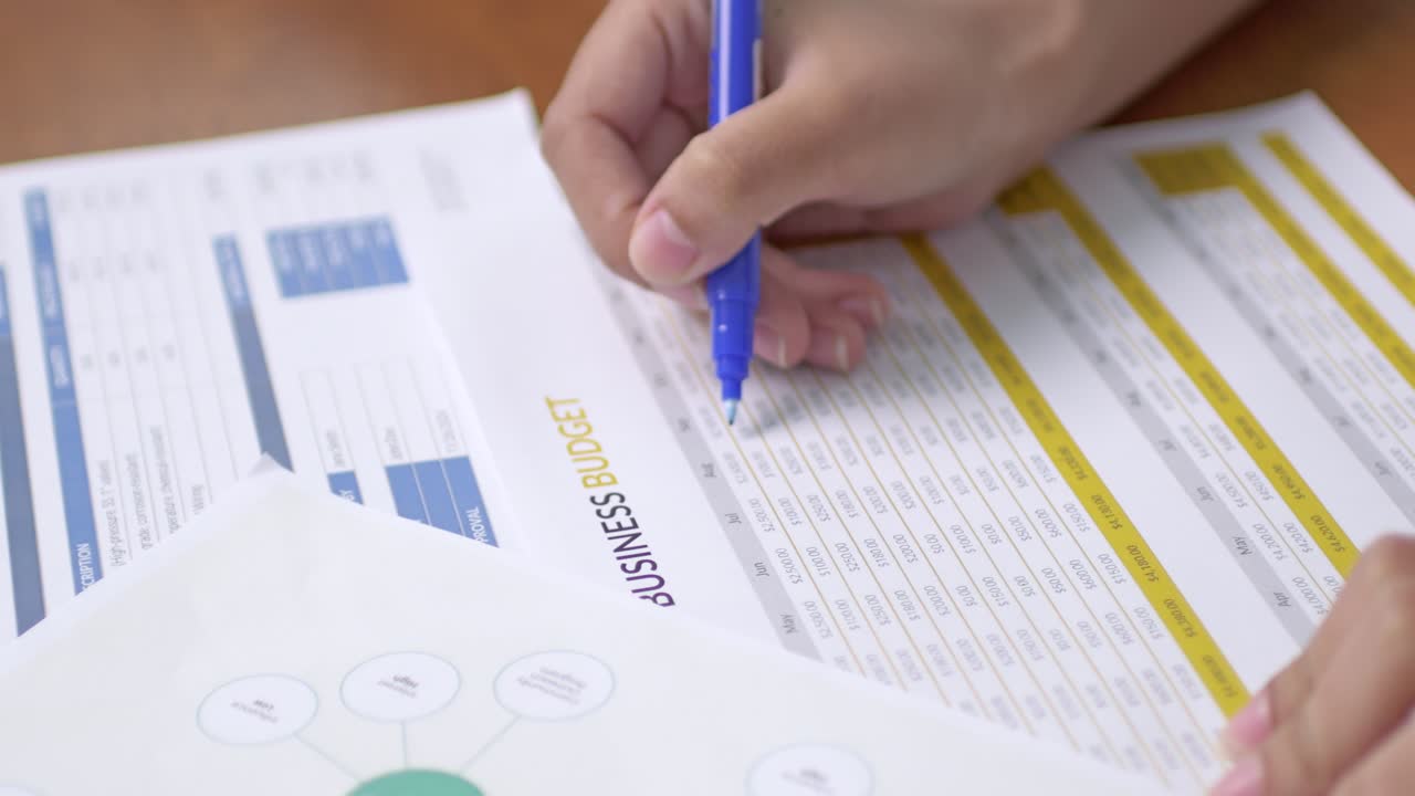 A hand reviews important business documents highlighting the focus productivity and decision-making