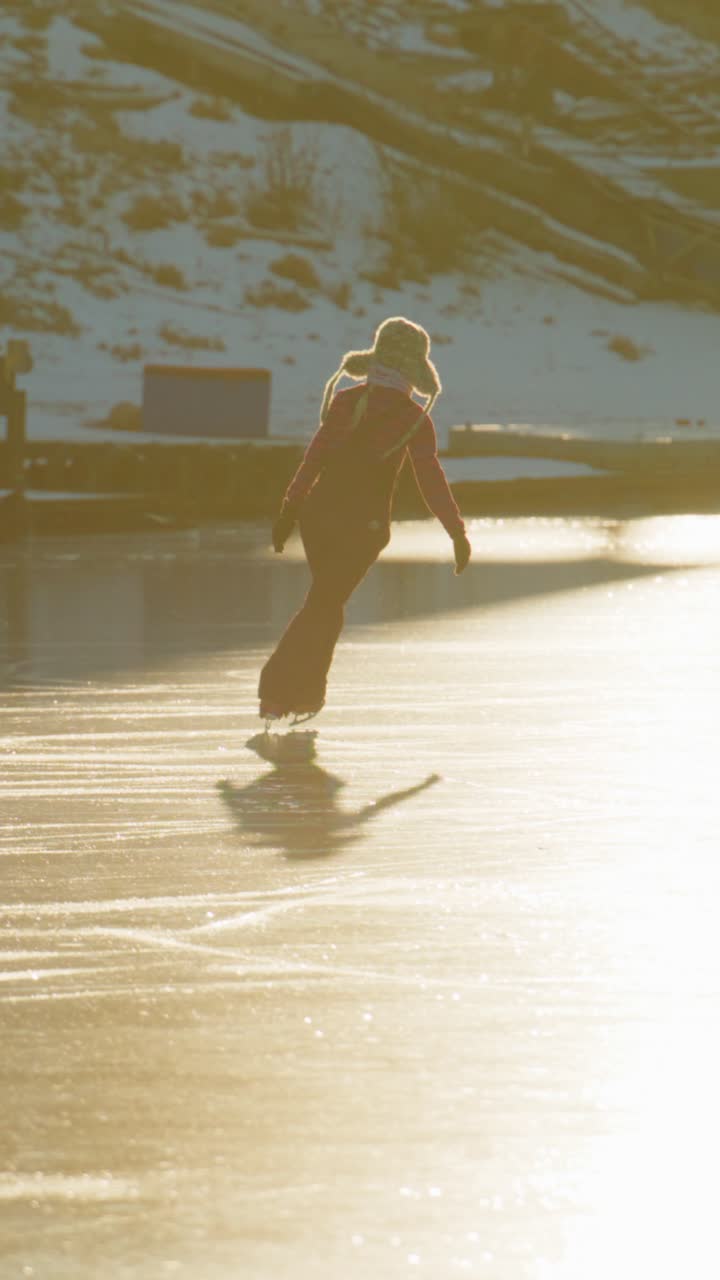 A young figure skater gracefully glides across a glistening ice rink, bathed in warm golden light, showcasing the beauty of winter sports and the joy of skating in a magical setting
