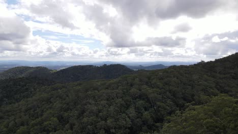 aerial drone moves forward above mount boulder, queensland, on a cloudy day
