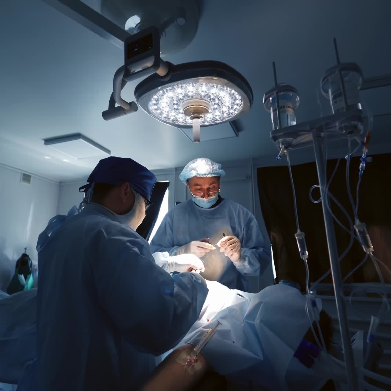 Surgical team operating on patient