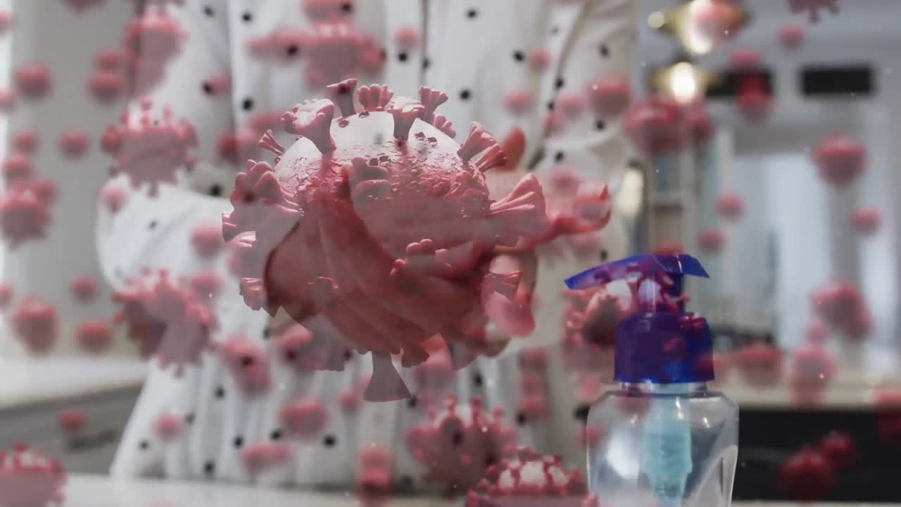 손을  ⁇ 는 사람 위의 코로나 19 세포의 애니메이션