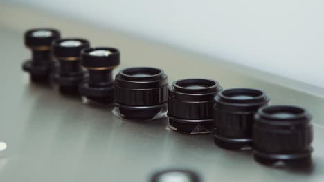 Showcasing-seven-black-lenses-for-an-army-scope-laid-side-by-side