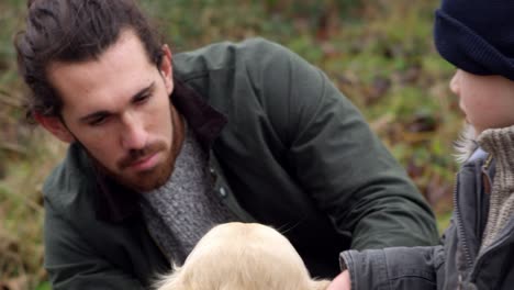 family on winter walk in countryside with dog shot on r3d