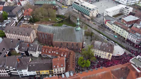 aerial rising up tilting down, fck football audience fans crowd celebrating win at the bars of old city in kaiserslautern germany