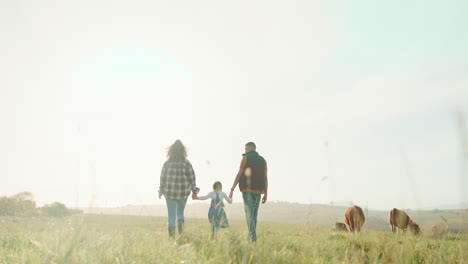 farm, parents and child walking in the countryside