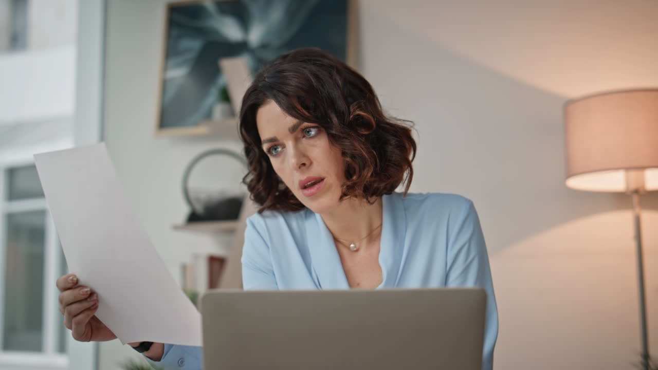 Overloaded worker reviewing papers sitting corporate workplace office closeup