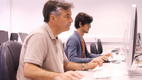 Student and teacher working on computer