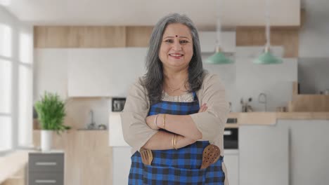 Happy-Indian-aged-housewife-standing-crossed-hands