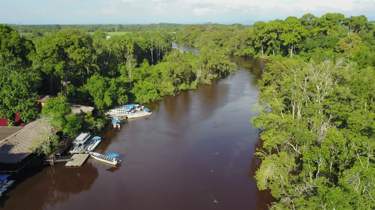 Malaysia,Kota Kinabulu,Aerial footage forward following the river,over wetland center with boats towards the mangrove forest on a sunny day.