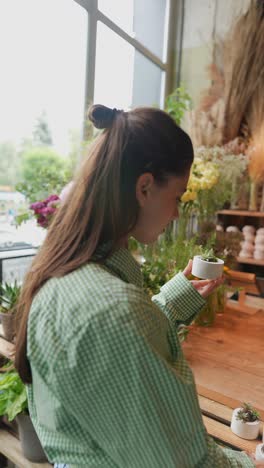 woman browsing plants in a flower shop