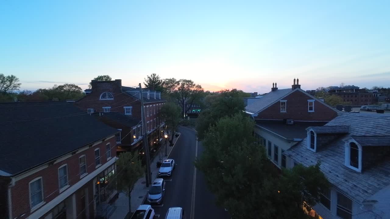 Drone flight over main street of small american town at dusk