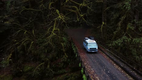 aerial pan of a vw van on a bridge in the pacific northwest