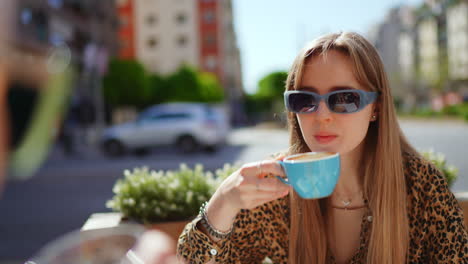 young woman enjoying coffee outdoors in a city cafe