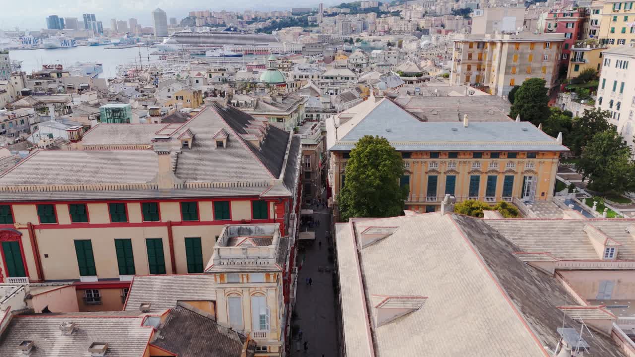 Genoa’s historic center with tourists walking between ancient buildings, aerial view