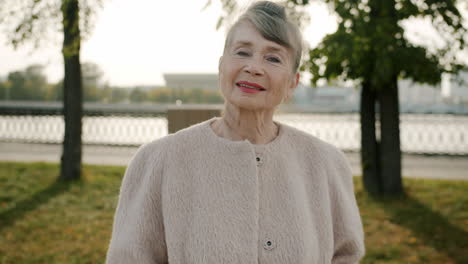portrait of a smiling senior woman in a park