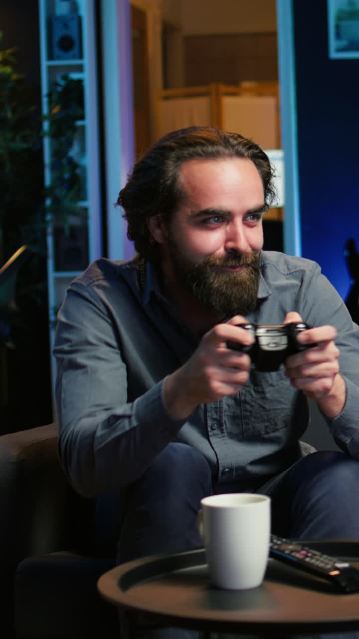 Vertical video Focused man playing videogame in neon illuminated home