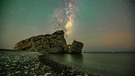 The-milky-way-passes-above-a-rock-on-the-ocean-coastline