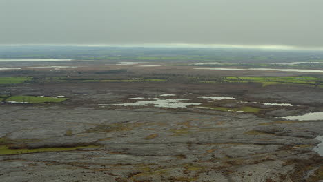 Aerial pan across Burren landscape showcasing seasonal turloughs and drainage features