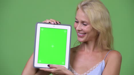 young happy beautiful businesswoman showing digital tablet
