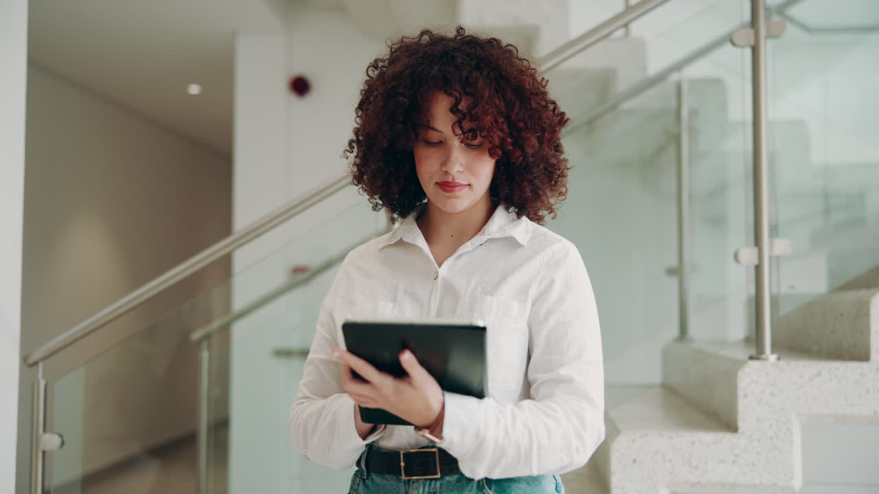 Young woman in office using tablet