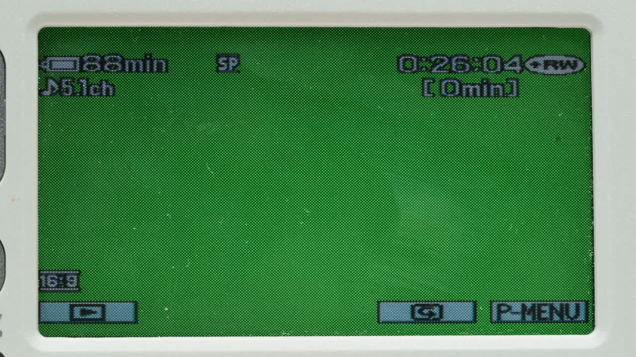 Old vintage video camera close-up. Popular retro camcorder shooting. Chroma key green screen on video-camera monitor.