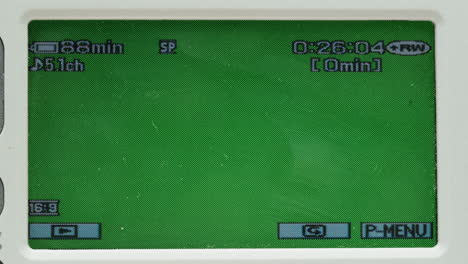old vintage video camera close-up. popular retro camcorder shooting. chroma key green screen on video-camera monitor.