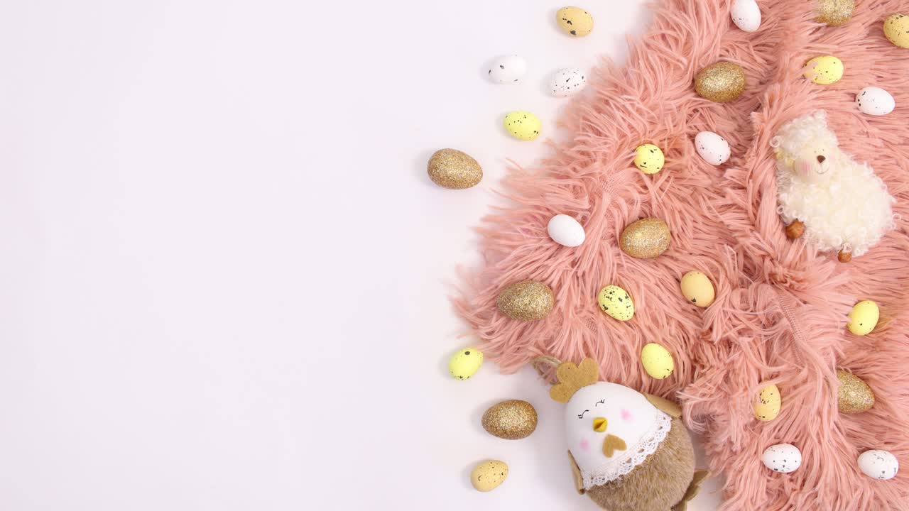 Gold and pastel pink Easter arrangement on right side of white background. Stop motion flat lay