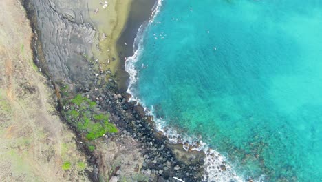 Aerial-of-eroded-coastline-and-green-seaside-fields-on-Hawaii-island