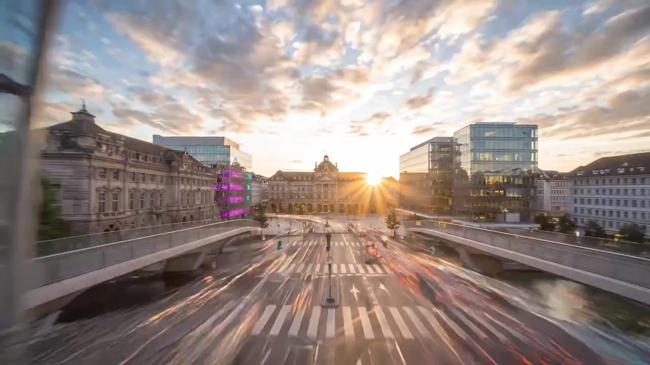 Aerial View of Modern Architecture and Streets with Vibrant Neon Lights at Dusk in a Bustling Urban Environment with a Historic Building in the Background