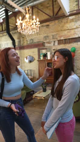 two young women talking in a cafe