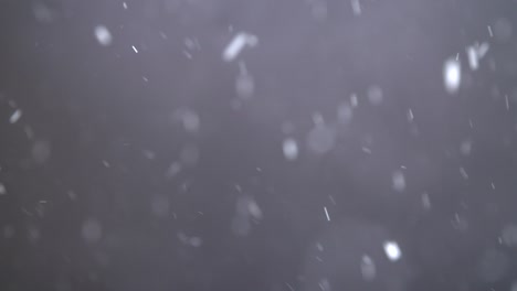 slow motion snowfall on black background