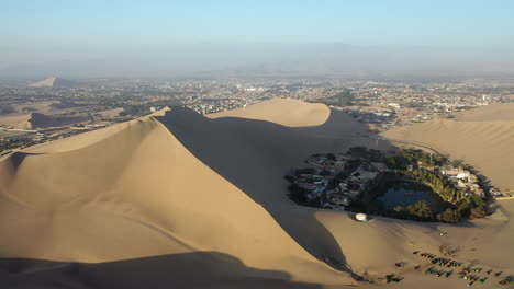 right dolly aerial sand dune huacachina peru shadow sunset oasis tourism