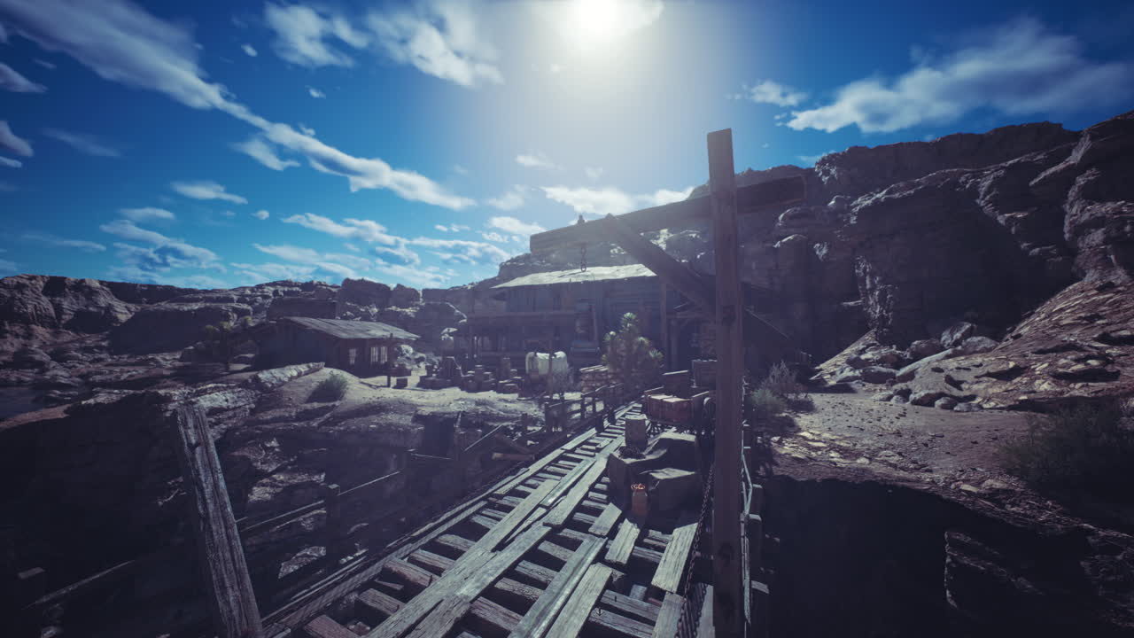 Old mining town with wooden structures and rail tracks under a cloudy sky
