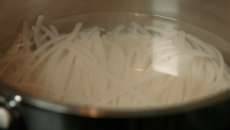 noodles for pad thai cooking in hot water pan